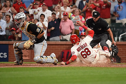 Aug 21, 2021; St. Louis, Missouri, USA; St. Louis Cardinals right fielder Lars Nootbaar (68) scores a run past Pittsburgh Pirates catcher Jacob Stallings (58) during the sixth inning at Busch Stadium. Mandatory Credit: Joe Puetz-USA TODAY Sports