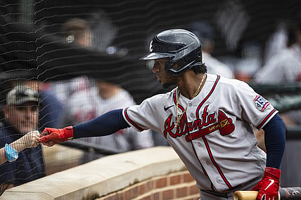 Aug 22, 2021; Baltimore, Maryland, USA; Atlanta Braves second baseman Ozzie Albies (1) first bumps a young fan during the first inning against the Baltimore Orioles at Oriole Park at Camden Yards. Mandatory Credit: Scott Taetsch-USA TODAY Sports
