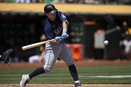 Aug 24, 2021; Oakland, California, USA; Seattle Mariners designated hitter Luis Torrens (22) connects for a two-RBI single against the Oakland Athletics during the third inning at RingCentral Coliseum. Mandatory Credit: D. Ross Cameron-USA TODAY Sports