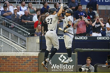 Aug 24, 2021; Atlanta, Georgia, USA; New York Yankees right fielder Giancarlo Stanton (27) celebrates with third baseman Rougned Odor (12) after a home run against the Atlanta Braves in the second inning at Truist Park. Mandatory Credit: Brett Davis-USA TODAY Sports
