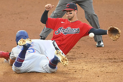Aug 24, 2021; Cleveland, Ohio, USA; Cleveland Indians second baseman Ernie Clement (28) reaches for the ball as Texas Rangers second baseman Nick Solak (15) steals second base in the second inning at Progressive Field. Mandatory Credit: David Richard-USA TODAY Sports