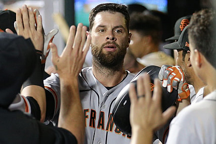 Aug 24, 2021; New York City, New York, USA; San Francisco Giants first baseman Brandon Belt (9) celebrates his solo home run against the New York Mets in the dugout with teammates during the fourth inning at Citi Field. Mandatory Credit: Brad Penner-USA TODAY Sports