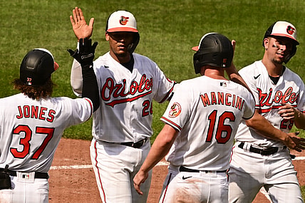 Aug 26, 2021; Baltimore, Maryland, USA; Baltimore Orioles catcher Pedro Severino (28) celebrates with second baseman Jahmai Jones (37), right fielder Trey Mancini (16) and  shortstop Ramon Urias (29) after hitting a fifth inning grand slam against the Los Angeles Angels  at Oriole Park at Camden Yards. Mandatory Credit: Tommy Gilligan-USA TODAY Sports