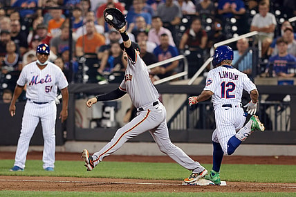 Aug 26, 2021; New York City, New York, USA; New York Mets shortstop Francisco Lindor (12) beats a throw caught by San Francisco Giants second baseman Wilmer Flores (41) for a single during the third inning at Citi Field. Mandatory Credit: Vincent Carchietta-USA TODAY Sports