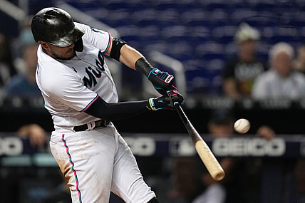 Aug 26, 2021; Miami, Florida, USA; Miami Marlins shortstop Miguel Rojas (19) connects for a two-run homerun in the 2nd inning against the Washington Nationals at loanDepot park. Mandatory Credit: Jasen Vinlove-USA TODAY Sports