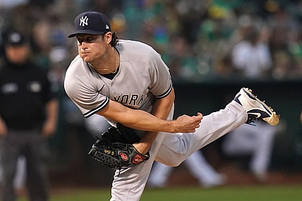 Aug 27, 2021; Oakland, California, USA; New York Yankees pitcher Gerrit Cole (45) follows through on a pitch against the Oakland Athletics in the third inning at RingCentral Coliseum. Mandatory Credit: Cary Edmondson-USA TODAY Sports