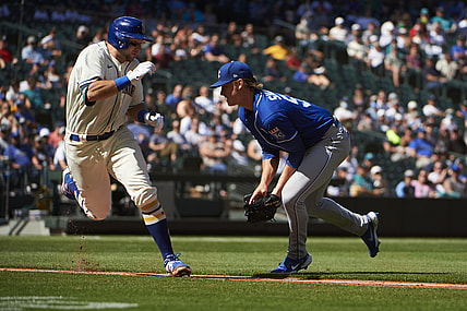 Aug 29, 2021; Seattle, Washington, USA;  Kansas City Royals starting pitcher Brady Singer (51) tags Seattle Mariners catcher Cal Raleigh (29) for an out during the fourth inning at T-Mobile Park. Mandatory Credit: Troy Wayrynen-USA TODAY Sports