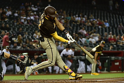 Aug 30, 2021; Phoenix, Arizona, USA;  San Diego Padres shortstop Fernando Tatis Jr. (23) hits a two run home run in the first inning against the Arizona Diamondbacks at Chase Field. Mandatory Credit: Matt Kartozian-USA TODAY Sports