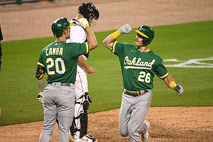 Aug 31, 2021; Detroit, Michigan, USA; Oakland Athletics third baseman Matt Chapman (26) celebrates with left fielder Mark Canha (20) after hitting a home run against the Detroit Tigers during the ninth inning at Comerica Park. Mandatory Credit: Tim Fuller-USA TODAY Sports
