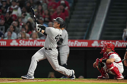 Aug 31, 2021; Anaheim, California, USA; New York Yankees first baseman Anthony Rizzo (48) follows through on a solo home run in the fourth inning as Los Angeles Angels catcher Max Stassi (33) watches at Angel Stadium. Mandatory Credit: Kirby Lee-USA TODAY Sports