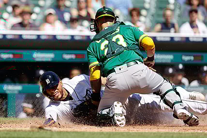 Sep 2, 2021; Detroit, Michigan, USA;  Oakland Athletics catcher Yan Gomes (23) tags Detroit Tigers center fielder Victor Reyes (22) out at home in the third inning at Comerica Park. Mandatory Credit: Rick Osentoski-USA TODAY Sports