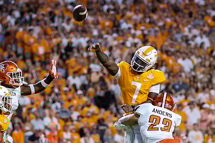 Sep 2, 2021; Knoxville, Tennessee, USA; Tennessee Volunteers quarterback Joe Milton III (7) throws the ball against Bowling Green Falcons linebacker Darren Anders (23) during the first quarter at Neyland Stadium. Mandatory Credit: Randy Sartin-USA TODAY Sports