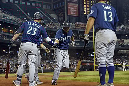 Sep 4, 2021; Phoenix, Arizona, USA; Seattle Mariners third baseman Kyle Seager (15) slaps hands with teammates after hitting a three run home run against the Arizona Diamondbacks during the sixth inning at Chase Field. Mandatory Credit: Joe Camporeale-USA TODAY Sports