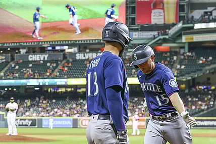 Sep 7, 2021; Houston, Texas, USA; Seattle Mariners second baseman Abraham Toro (13) celebrates a home run hit by third baseman Kyle Seager (15) against the Houston Astros in the sixth inning at Minute Maid Park. Mandatory Credit: Thomas Shea-USA TODAY Sports