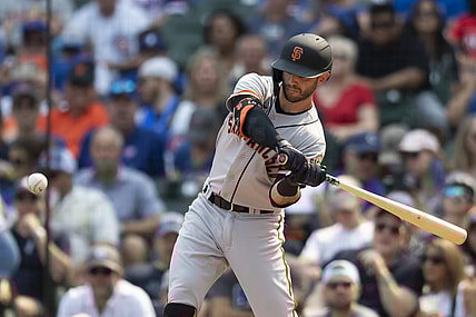 Sep 11, 2021; Chicago, Illinois, USA; San Francisco Giants second baseman Tommy La Stella (18) hits a two RBI single during the second inning against the Chicago Cubs at Wrigley Field. Mandatory Credit: Patrick Gorski-USA TODAY Sports