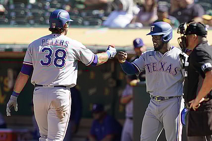 Sep 11, 2021; Oakland, California, USA; Texas Rangers left fielder DJ Peters (38) is congratulated by right fielder Adolis Garcia (53) after hitting a home run during the eighth inning against the Oakland Athletics at RingCentral Coliseum. Mandatory Credit: Darren Yamashita-USA TODAY Sports