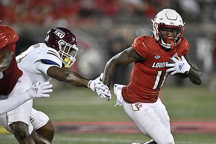Sep 11, 2021; Louisville, Kentucky, USA;  Louisville Cardinals wide receiver Josh Johnson (11) runs the ball past the reach of Eastern Kentucky Colonels linebacker Je'Vari Anderson (14) during the second quarter at Cardinal Stadium. Mandatory Credit: Jamie Rhodes-USA TODAY Sports