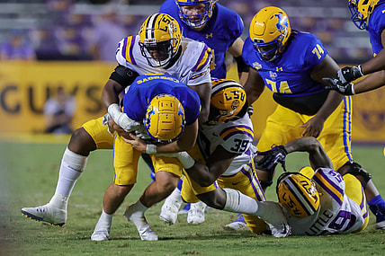 Sep 11, 2021; Baton Rouge, Louisiana, USA;  LSU Tigers defensive lineman Maason Smith (0) sacks McNeese State Cowboys quarterback Cody Orgeron (8) during the second half at Tiger Stadium. Mandatory Credit: Stephen Lew-USA TODAY Sports