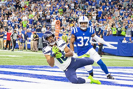 Sep 12, 2021; Indianapolis, Indiana, USA; Seattle Seahawks wide receiver Tyler Lockett (16) catches a touchdown pass while Indianapolis Colts safety Khari Willis (37) defends in the first quarter at Lucas Oil Stadium. Mandatory Credit: Trevor Ruszkowski-USA TODAY Sports
