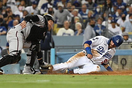 Sep 13, 2021; Los Angeles, California, USA; Los Angeles Dodgers second baseman Gavin Lux (9) is out at home trying to score against Arizona Diamondbacks catcher Carson Kelly (18) in the fourth inning on a sacrifice fly hit by Los Angeles Dodgers right fielder Mookie Betts (not pictured)  at Dodger Stadium. Mandatory Credit: Richard Mackson-USA TODAY Sports