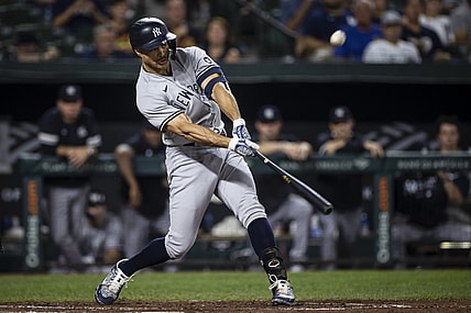 Sep 14, 2021; Baltimore, Maryland, USA; New York Yankees left fielder Giancarlo Stanton (27) hits a two run home run against the Baltimore Orioles during the third inning at Oriole Park at Camden Yards. Mandatory Credit: Scott Taetsch-USA TODAY Sports