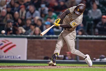 Sep 15, 2021; San Francisco, California, USA; San Diego Padres second baseman Adam Frazier (12) singles to right field against the San Francisco Giants during the fifth inning at Oracle Park. Mandatory Credit: Neville E. Guard-USA TODAY Sports