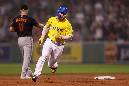 Sep 17, 2021; Boston, Massachusetts, USA; Boston Red Sox left fielder Alex Verdugo (right) advances to third base during the second inning against the Baltimore Orioles at Fenway Park. Mandatory Credit: Paul Rutherford-USA TODAY Sports
