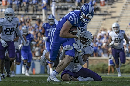 Sep 18, 2021; Durham, North Carolina, USA; Duke Blue Devils tight end Cole Finney (82) is tackled by Northwestern Wildcats safety Brandon Joseph (16) during the second quarter at Wallace Wade Stadium. Mandatory Credit: William Howard-USA TODAY Sports