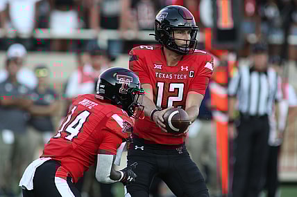 Sep 18, 2021; Lubbock, Texas, USA; Texas Tech Red Raiders quarter back Tyler Shough (12) hands off to running back Xavier White (14) against the Florida International Panthers during the first half at Jones AT&T Stadium. Mandatory Credit: Michael C. Johnson-USA TODAY Sports
