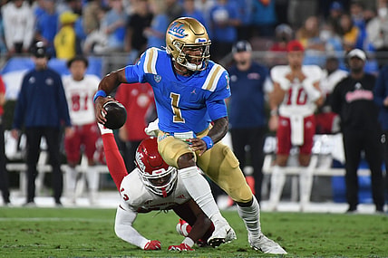 Sep 18, 2021; Pasadena, California, USA; UCLA Bruins quarterback Dorian Thompson-Robinson (1) looks to pass against Fresno State Bulldogs defensive back Justin Houston (13) in the second quarter at Rose Bowl. Mandatory Credit: Richard Mackson-USA TODAY Sports
