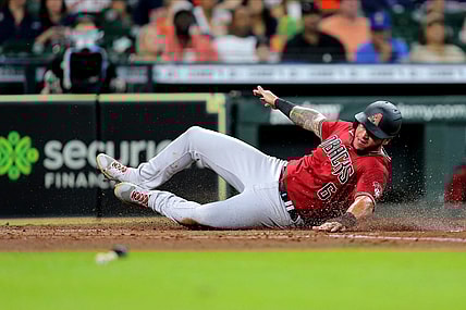 Sep 19, 2021; Houston, Texas, USA; Arizona Diamondbacks left fielder David Peralta (6) slides across home plate to score a run against the Houston Astros during the fourth inning at Minute Maid Park. Mandatory Credit: Erik Williams-USA TODAY Sports