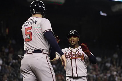 Sep 20, 2021; Phoenix, Arizona, USA; Atlanta Braves second baseman Ozzie Albies (1) celebrates with first baseman Freddie Freeman (5) after scoring runs against the Arizona Diamondbacks in the third inning at Chase Field. Mandatory Credit: Rick Scuteri-USA TODAY Sports