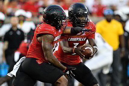 Sep 17, 2021; Louisville, Kentucky, USA;  Louisville Cardinals quarterback Malik Cunningham (3) prepares to handoff the ball to Louisville Cardinals running back Jalen Mitchell (15) during the first quarter against the UCF Knights at Cardinal Stadium. Louisville defeated Central Florida 42-35. Mandatory Credit: Jamie Rhodes-USA TODAY Sports