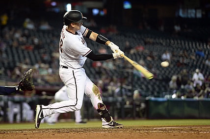 Sep 23, 2021; Phoenix, Arizona, USA; Arizona Diamondbacks catcher Carson Kelly (18) hits a three run home run against the Atlanta Braves during the seventh inning at Chase Field. Mandatory Credit: Joe Camporeale-USA TODAY Sports