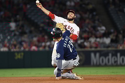 Sep 24, 2021; Anaheim, California, USA; Los Angeles Angels second baseman David Fletcher (22) throws out Seattle Mariners third baseman Ty France (23) as Seattle Mariners shortstop J.P. Crawford (not pictured) scored on the play in the third inning at Angel Stadium. Mandatory Credit: Richard Mackson-USA TODAY Sports