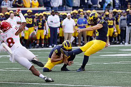 Sep 25, 2021; Ann Arbor, Michigan, USA;  Michigan Wolverines place kicker Jake Moody (13) kicks a field goal out of the hold by Michigan Wolverines punter Brad Robbins (91) in first half against the Rutgers Scarlet Knights at Michigan Stadium. Mandatory Credit: Rick Osentoski-USA TODAY Sports