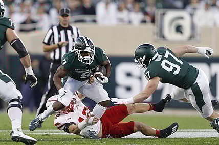 Sep 25, 2021; East Lansing, Michigan, USA; Nebraska Cornhuskers linebacker Nick Henrich (42) attempts to bring down Michigan State Spartans running back Kenneth Walker III (9) during the first quarter at Spartan Stadium. Mandatory Credit: Raj Mehta-USA TODAY Sports