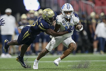 Sep 25, 2021; Atlanta, Georgia, USA; North Carolina Tar Heels wide receiver Josh Downs (11) is tackled by Georgia Tech Yellow Jackets linebacker Charlie Thomas (25) in the first quarter at Mercedes-Benz Stadium. Mandatory Credit: Brett Davis-USA TODAY Sports