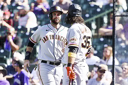 Sep 26, 2021; Denver, Colorado, USA; San Francisco Giants first baseman Brandon Belt (9) celebrates with shortstop Brandon Crawford (35) after scoring against the Colorado Rockies off a hit by left fielder Kris Bryant (23) in the fifth inning at Coors Field. Mandatory Credit: Michael Ciaglo-USA TODAY Sports