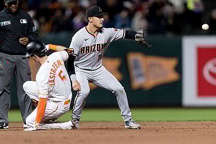 Sep 28, 2021; San Francisco, California, USA; San Francisco Giants right fielder Mike Yastrzemski (5) slides into second base with a double against Arizona Diamondbacks shortstop Josh Rojas (10) in the fourth inning at Oracle Park. Mandatory Credit: John Hefti-USA TODAY Sports