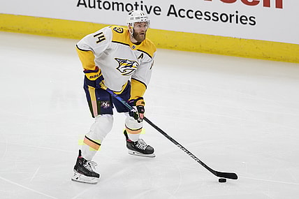 Apr 23, 2021; Chicago, Illinois, USA; Nashville Predators defenseman Mattias Ekholm (14) looks to pass the puck against the Chicago Blackhawks during the first period of an NHL hockey game at United Center. Mandatory Credit: Kamil Krzaczynski-USA TODAY Sports