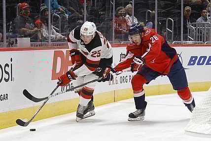 Sep 29, 2021; Washington, District of Columbia, USA; New Jersey Devils left wing Nolan Foote (25) skates with the puck as Washington Capitals defenseman Vincent Iorio (28) defends during the first period at Capital One Arena. Mandatory Credit: Geoff Burke-USA TODAY Sports
