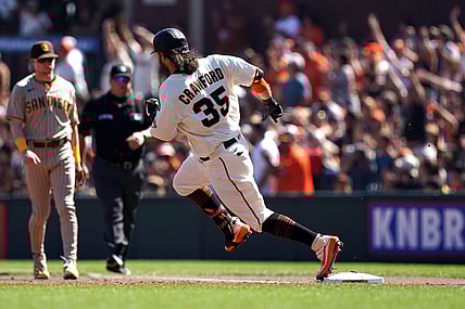 Oct 2, 2021; San Francisco, California, USA; San Francisco Giants shortstop Brandon Crawford (35) rounds first base on a double during the second inning against the San Diego Padres at Oracle Park. Mandatory Credit: Darren Yamashita-USA TODAY Sports