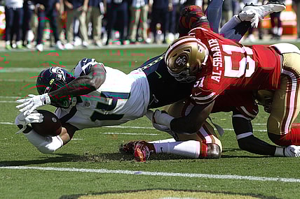 Oct 3, 2021; Santa Clara, California, USA; Seattle Seahawks wide receiver DK Metcalf (14) dives for the end zone while being tackled by San Francisco 49ers linebacker Azeez Al-Shaair (51) and cornerback Jimmie Ward (1) during the second quarter at Levi's Stadium. Mandatory Credit: Darren Yamashita-USA TODAY Sports