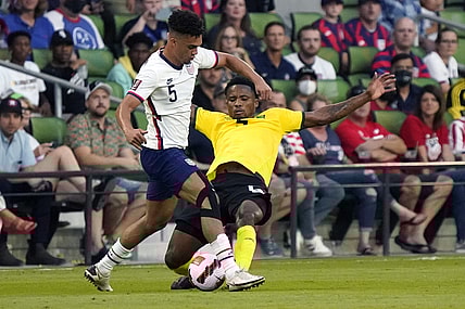 Oct 7, 2021; Austin, Texas, USA; United States defender Antonee Robinson (left) battles Jamaica defender Alvas Powel (right) during the first half of a FIFA World Cup Qualifier at Q2 Stadium. Mandatory Credit: Chuck Burton-USA TODAY Sports
