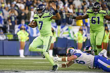 Oct 7, 2021; Seattle, Washington, USA; Seattle Seahawks quarterback Geno Smith (7) scrambles beyond the grasp of Los Angeles Rams defensive lineman Mike Hoecht (96) during the fourth quarter at Lumen Field. Mandatory Credit: Joe Nicholson-USA TODAY Sports