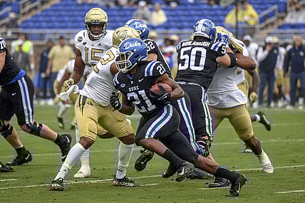 Oct 9, 2021; Durham, North Carolina, Duke Blue Devils running back Mataeo Durant (21) runs the ball against the Georgia Tech Yellow Jackets during the first quarter at Wallace Wade Stadium. Mandatory Credit: William Howard-USA TODAY Sports.