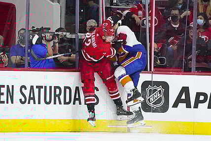 Oct 14, 2021; Raleigh, North Carolina, USA; Carolina Hurricanes center Jesperi Kotkaniemi (82) checks New York Islanders defenseman Ryan Pulock (6) during the first period at PNC Arena. Mandatory Credit: James Guillory-USA TODAY Sports