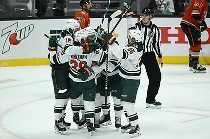 Oct 15, 2021; Anaheim, California, USA; Minnesota Wild left wing Marcus Foligno (17) (center) celebrates with teammates after scoring a game winning goal in the third period against the Anaheim Ducks at Honda Center. The Wild won 2-1. Mandatory Credit: Kiyoshi Mio-USA TODAY Sports