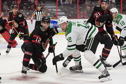 Oct 17, 2021; Ottawa, Ontario, CAN; Ottawa Senators center Shane Pinto (12) faces off against Dallas Stars center Radek Faska (12)  in the second period at the Canadian Tire Centre. Mandatory Credit: Marc DesRosiers-USA TODAY Sports